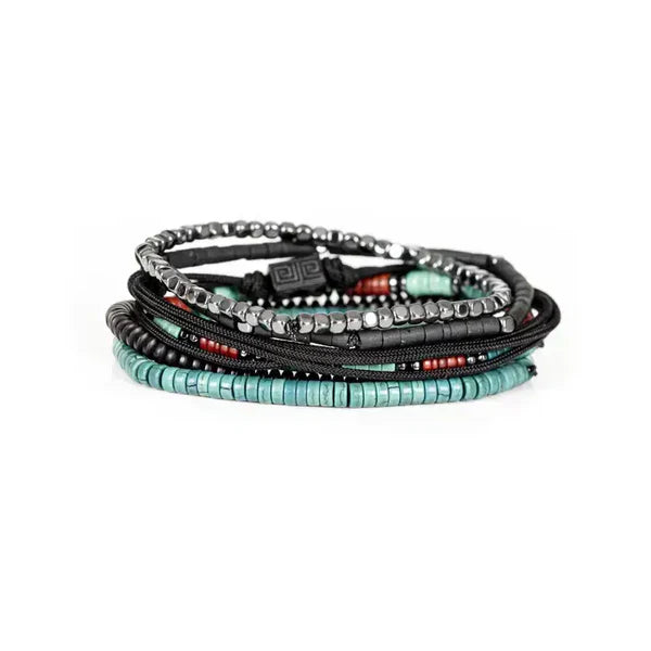 Layered men’s bracelet set featuring black hematite beads, turquoise and coral heishi bead accents, black braided cord details, and geometric metal elements, displayed on a white background.