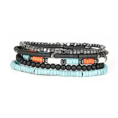 Layered men’s bracelet set featuring turquoise heishi beads, black matte beads, orange accent beads, and silver-tone hematite beads on elastic strands, displayed on a white background