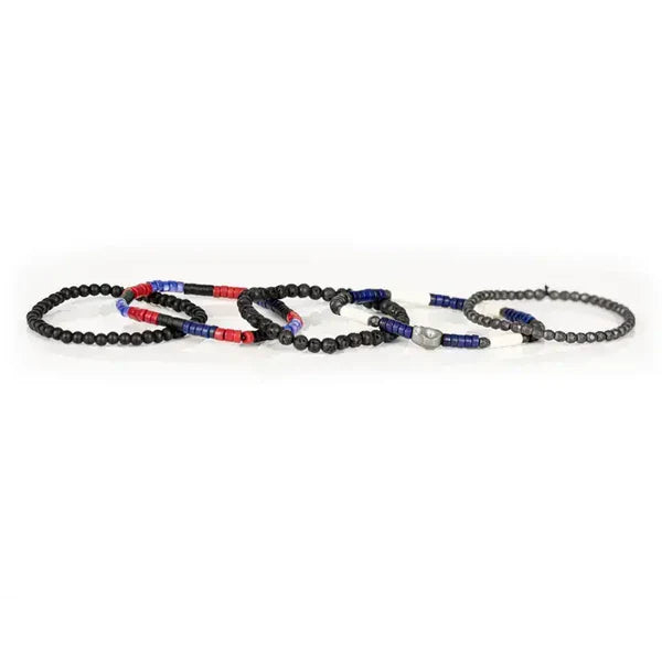 Layered men’s bracelet set featuring black matte beads, lava stone beads, faceted hematite beads, and red and blue accent beads with a silver-tone centerpiece, displayed on a white background.