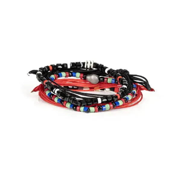 Layered men’s bracelet set featuring black and coral braided cord bracelets, multicolor bead accents, black faceted beads, and a silver-tone skull centerpiece, displayed on a white background.