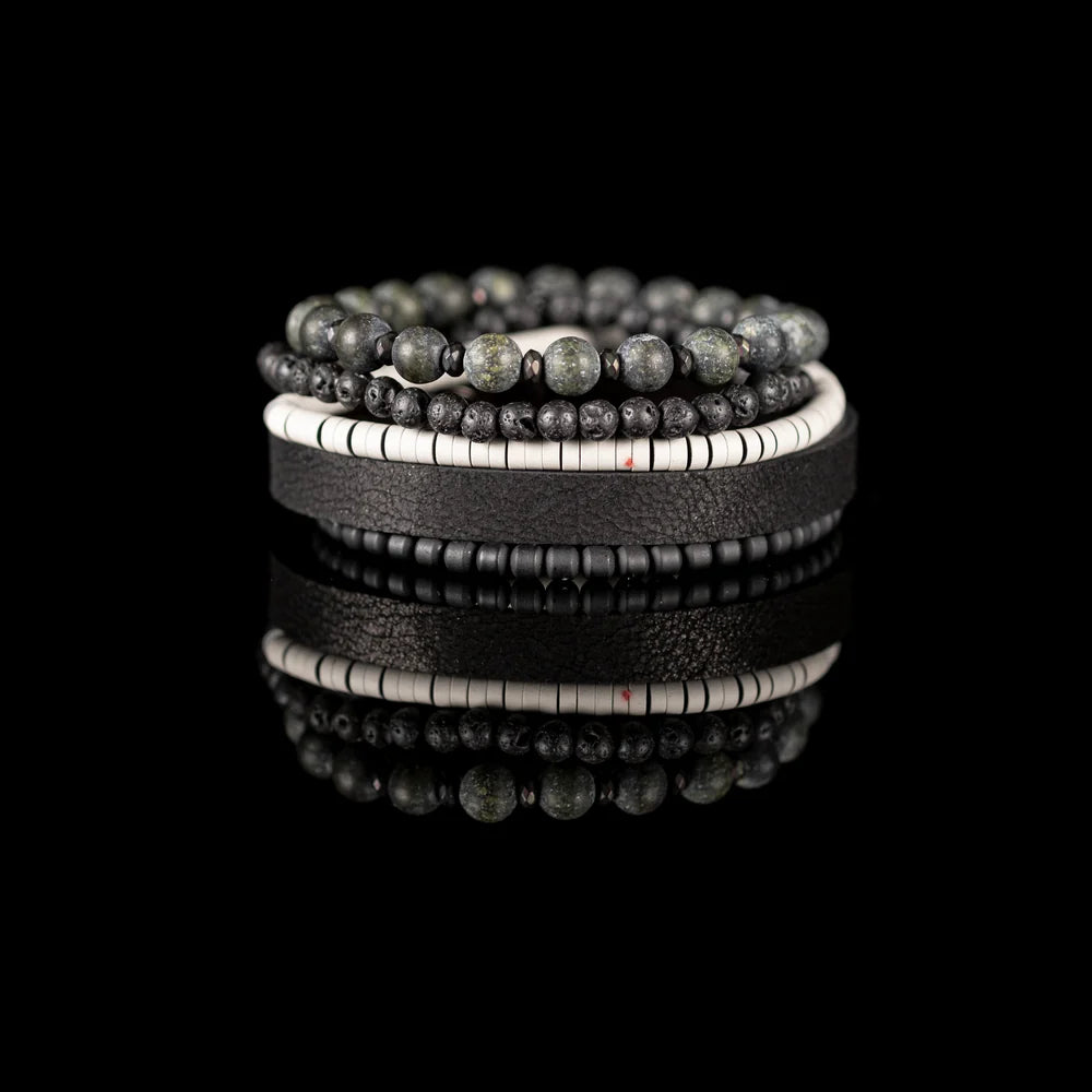Men's handcrafted black leather wrap bracelet set featuring natural green jasper gemstone beads, black lava stone beads, matte black beads, white heishi disc beads, and premium layered leather. Luxury men's stacked bracelet photographed on a clean white background.