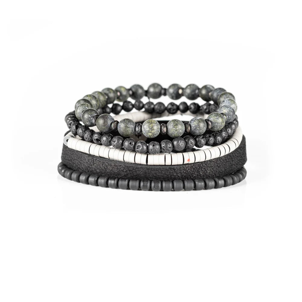 Men's handcrafted black leather wrap bracelet set featuring natural green jasper gemstone beads, black lava stone beads, matte black beads, white heishi disc beads, and premium layered leather. Luxury men's stacked bracelet photographed on a clean white background.