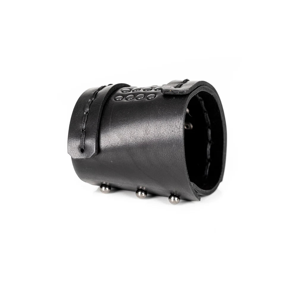 Black genuine leather cuff bracelet with hand-stitched wrap straps and black studded detailing, handcrafted statement accessory on a white background.