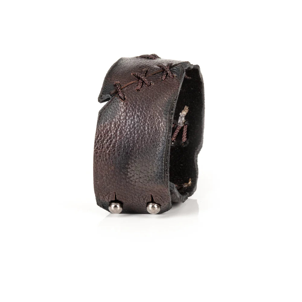 Black genuine leather cuff bracelet with hand-laced stitch detailing, raw cut edges, and a handcrafted artisan design, displayed on a white background.