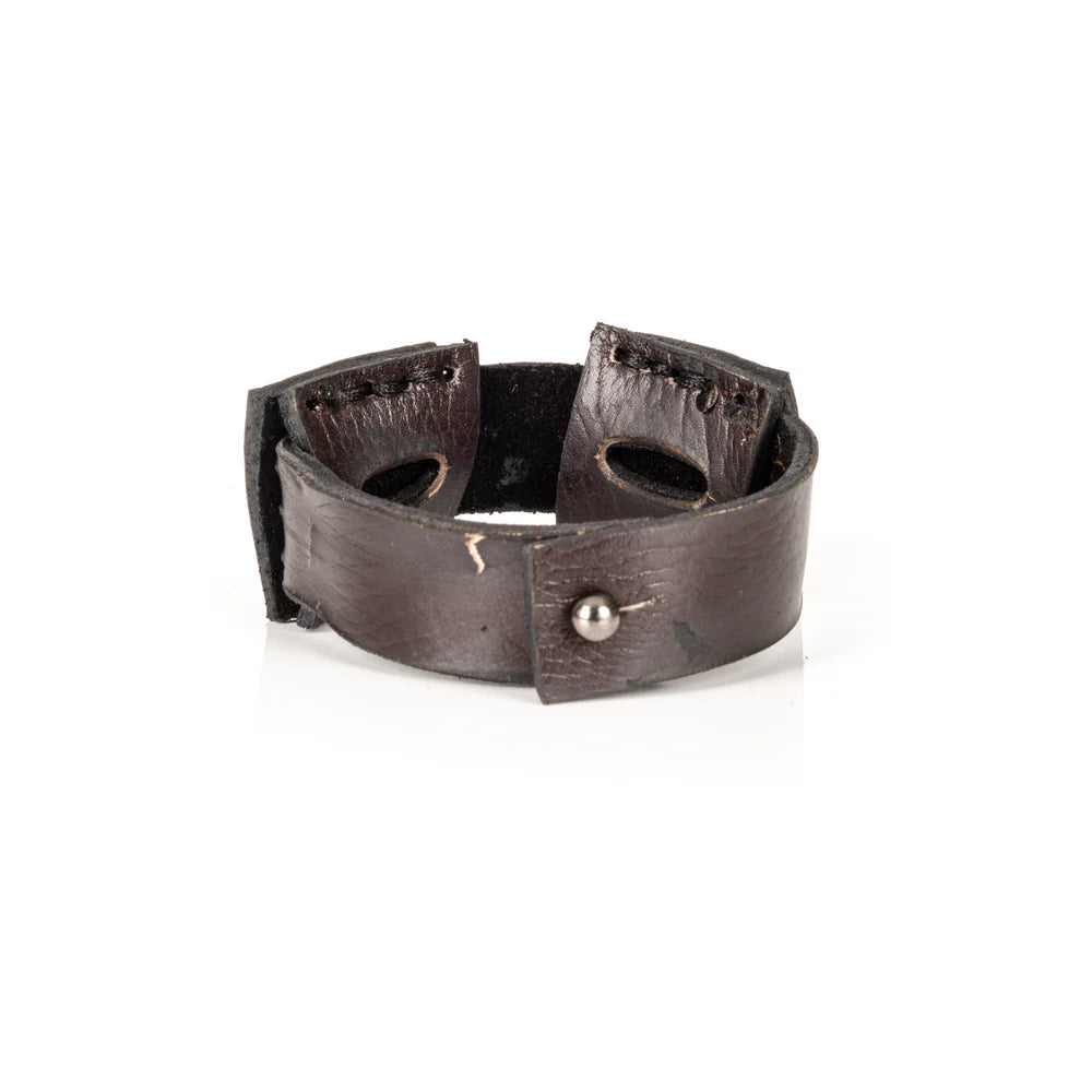 Black genuine leather cuff bracelet featuring layered square leather panels with oval cutout details and hand-stitched accents, handcrafted artisan statement accessory on a white background.