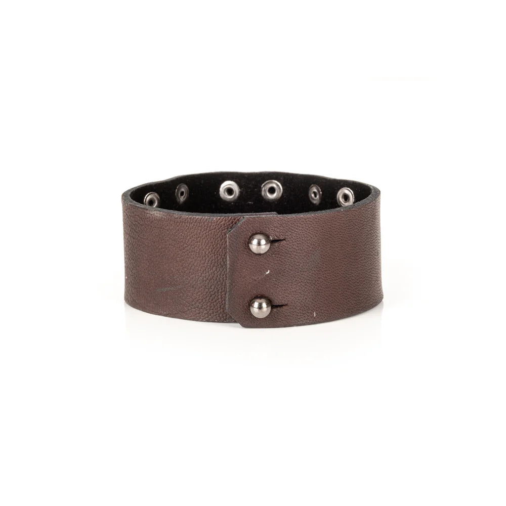Men's handcrafted genuine leather cuff bracelet in dark brown featuring a wide minimalist design with layered leather panels, matte black rivet detailing, and premium artisan craftsmanship. Luxury men's leather wristband photographed on a clean white background.