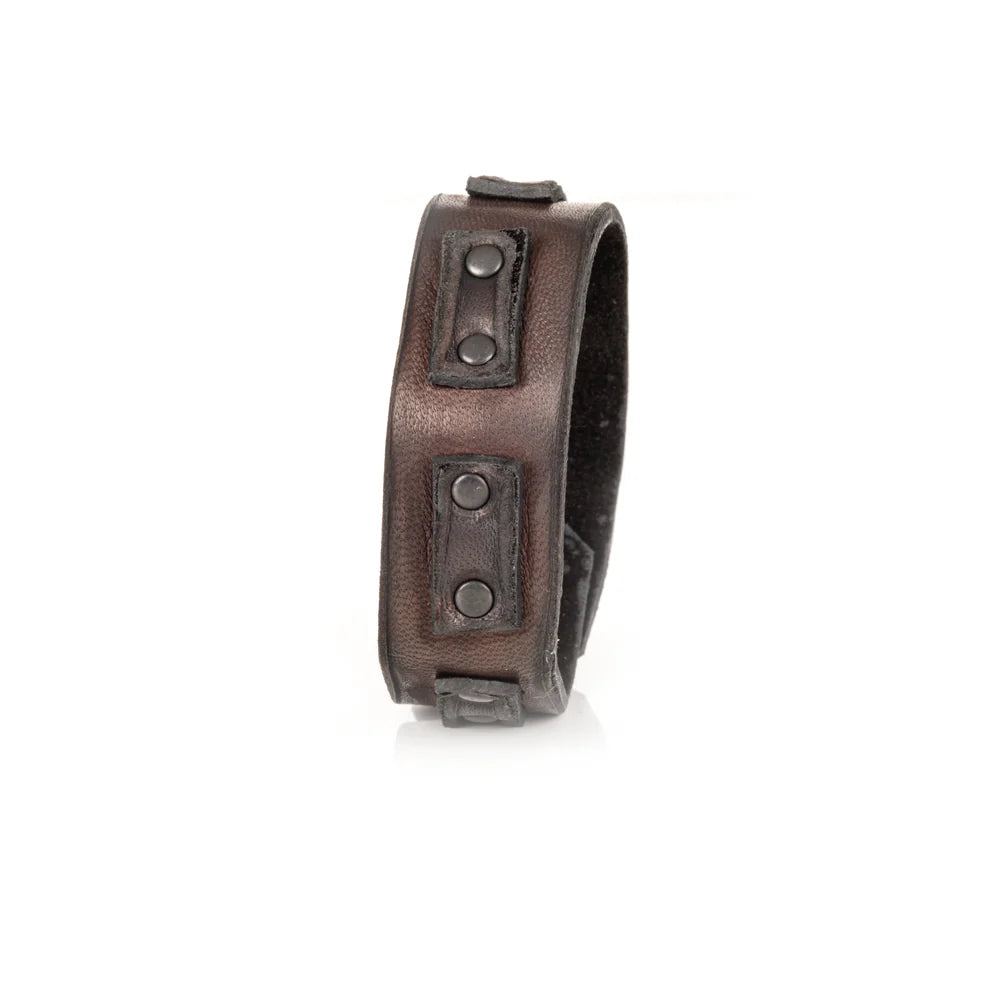 Men's handcrafted genuine leather cuff bracelet in dark brown featuring a wide minimalist design with black leather accent panels, matte black rivet hardware, and premium artisan craftsmanship. Luxury men's leather wristband photographed on a clean white background.