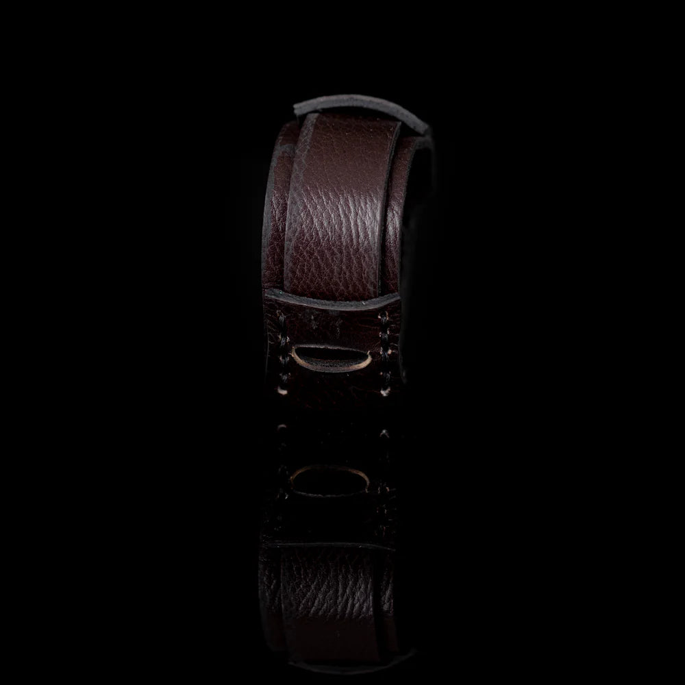 Handcrafted men's genuine leather cuff bracelet in dark brown with a wide layered wrap design, hand-stitched detailing, and a minimalist artisan closure. Premium handmade men's leather wristband photographed on a clean white background.