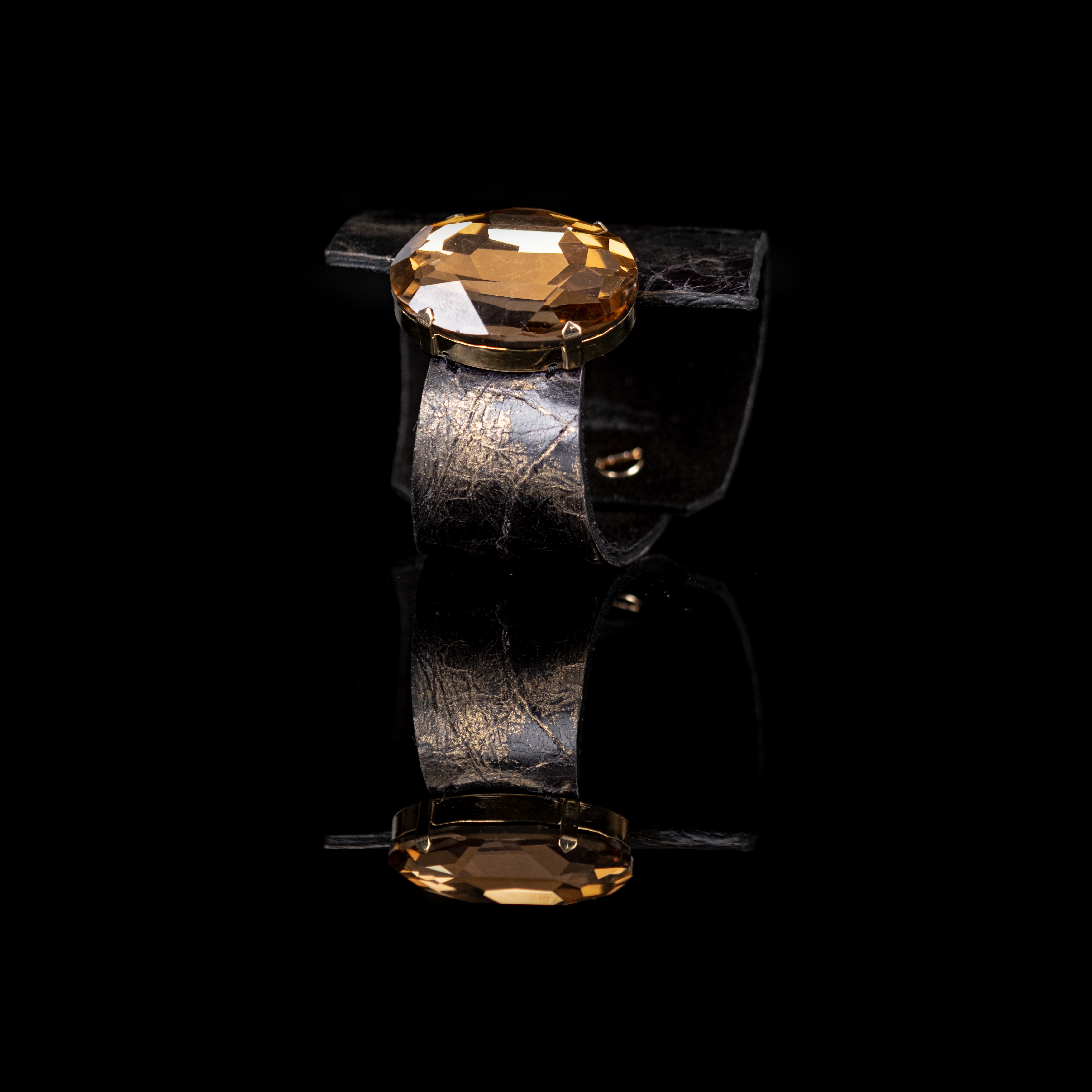Black leather cuff bracelet with large amber crystal centerpiece in gold setting, handmade statement bracelet by THE DARK