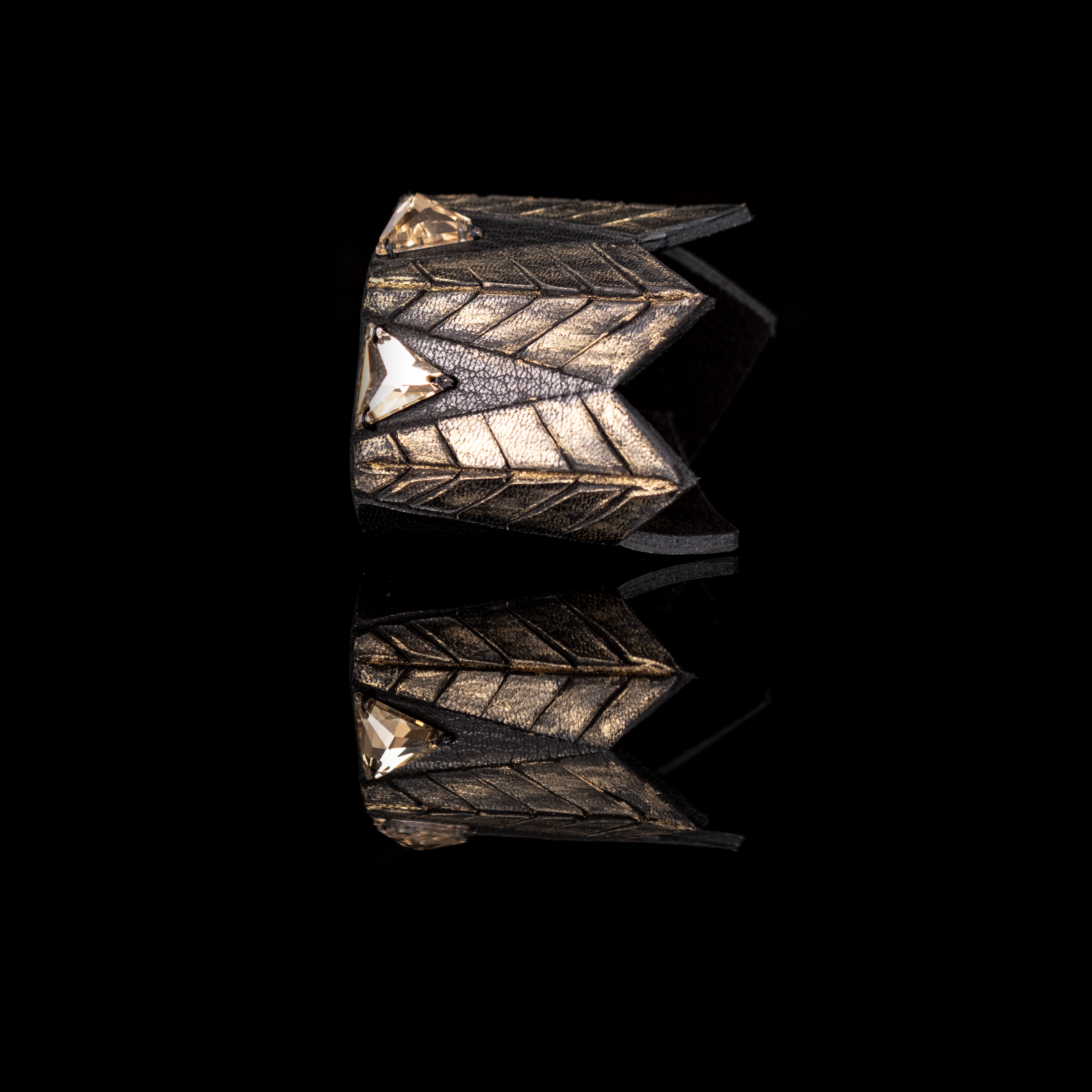 Black and gold leather cuff bracelet with geometric crystal accents and sculpted layered design