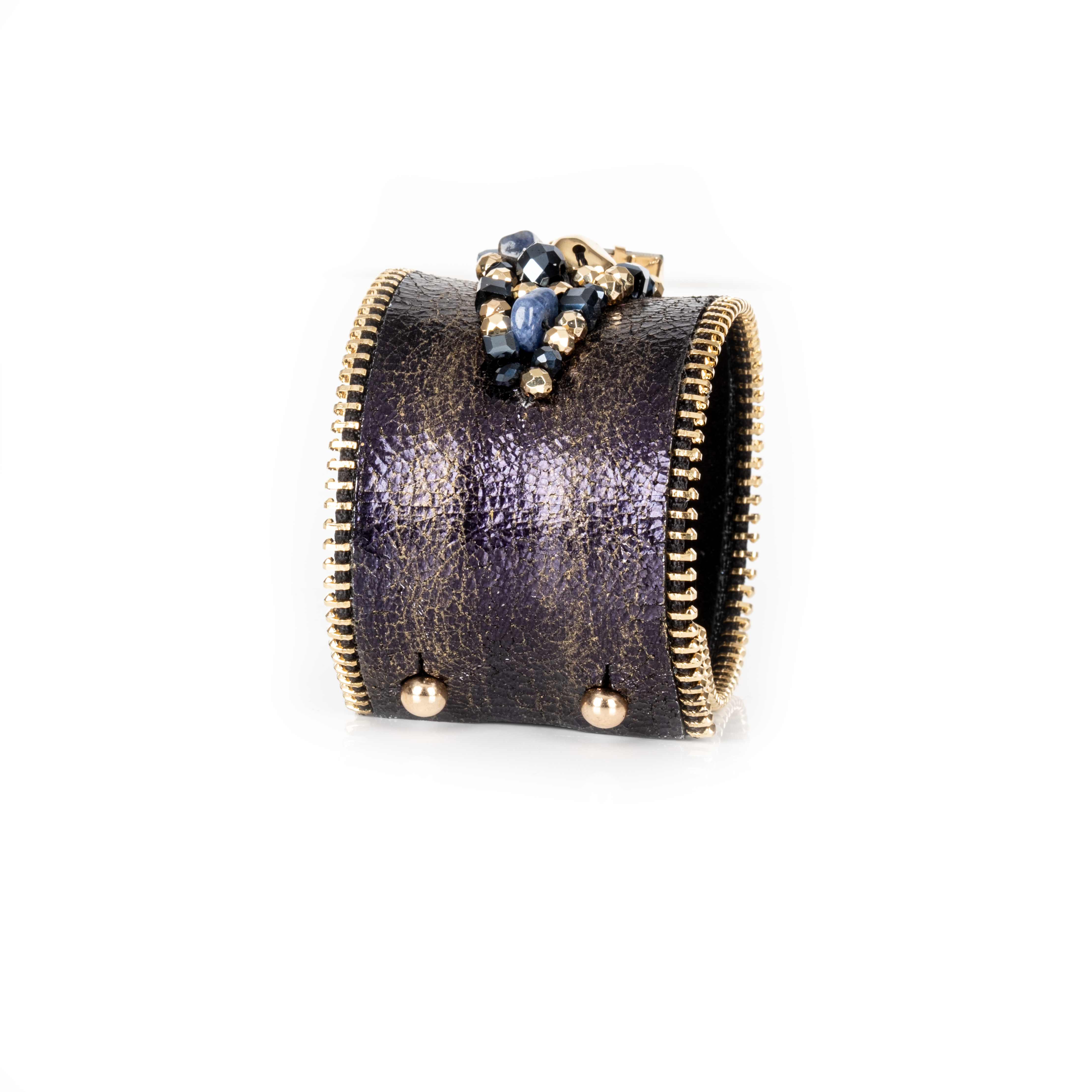 Dark leather cuff with gold brushed finish, zipper edges and blue-toned crystal cluster centerpiece