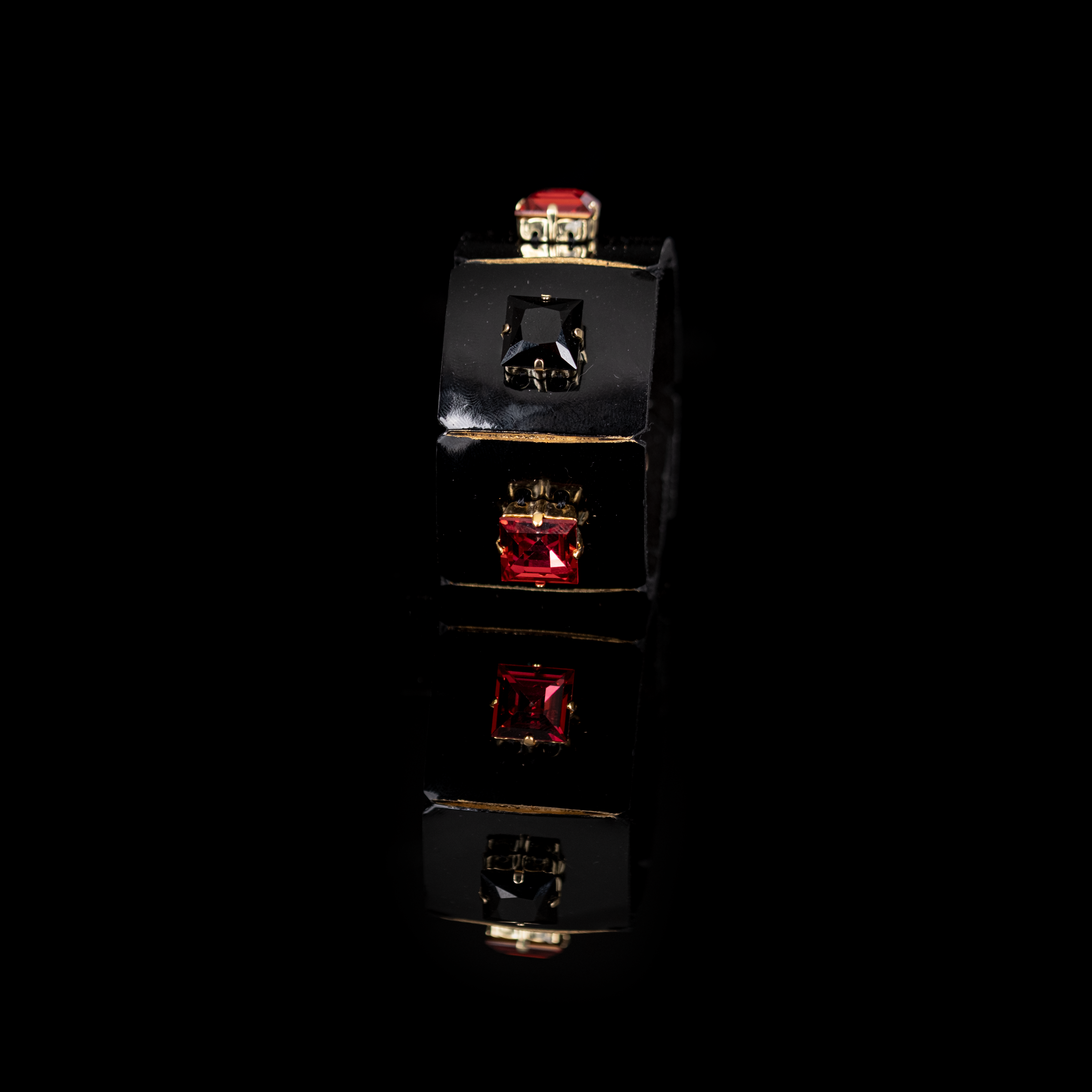 Black leather cuff bracelet with square red and black crystals in gold settings, minimalist geometric statement bracelet for women