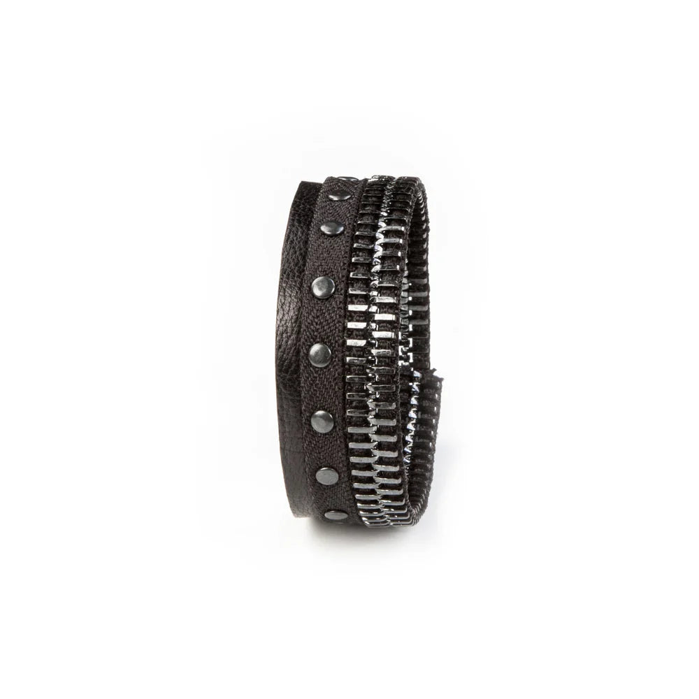 Men's black leather cuff bracelet featuring gunmetal zipper detailing, black metal studs, and layered textured leather bands for a bold industrial-inspired luxury look.