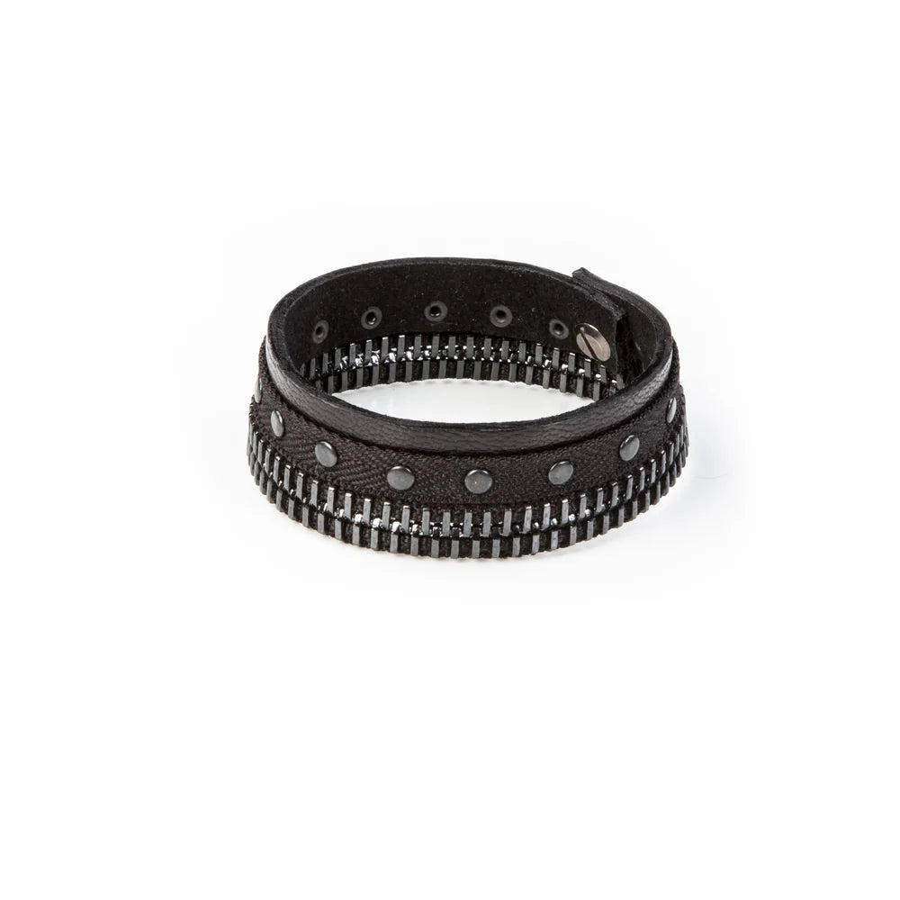 Men's black leather cuff bracelet featuring gunmetal zipper detailing, black metal studs, and layered textured leather bands for a bold industrial-inspired luxury look.