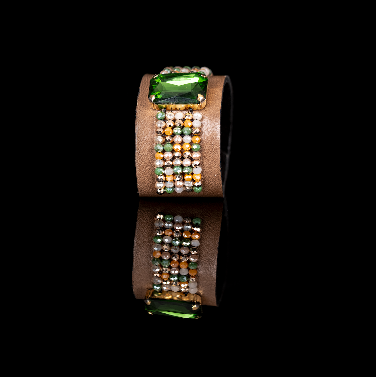Brown leather cuff bracelet with green crystal centerpiece and multicolor beaded detail