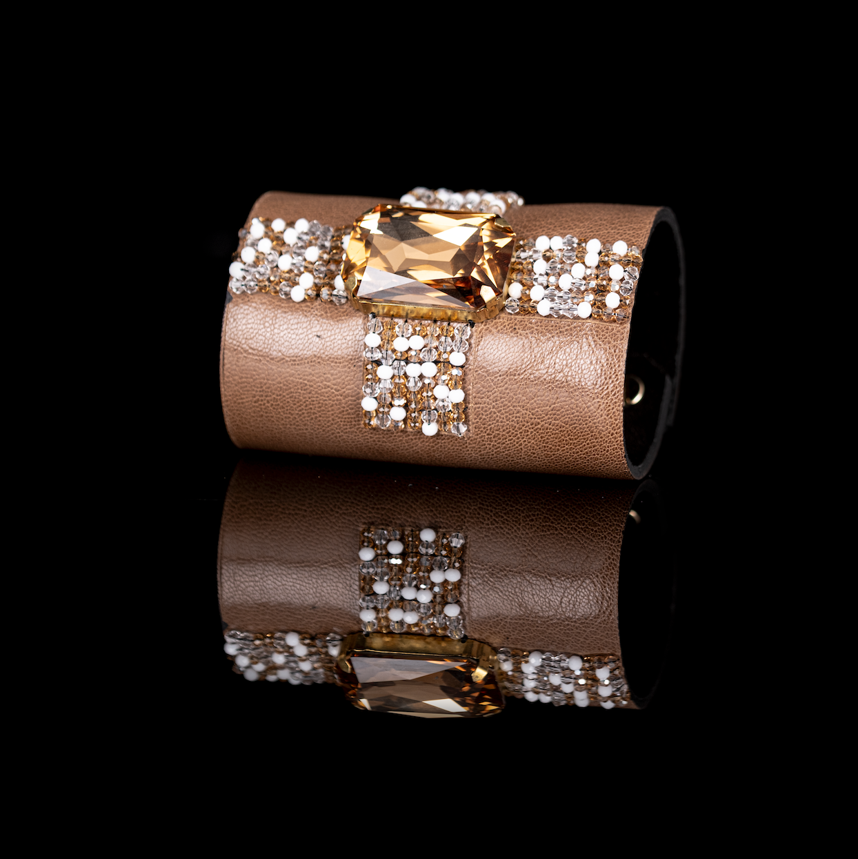 Taupe leather cuff bracelet with champagne crystal centerpiece and white beaded grid detail