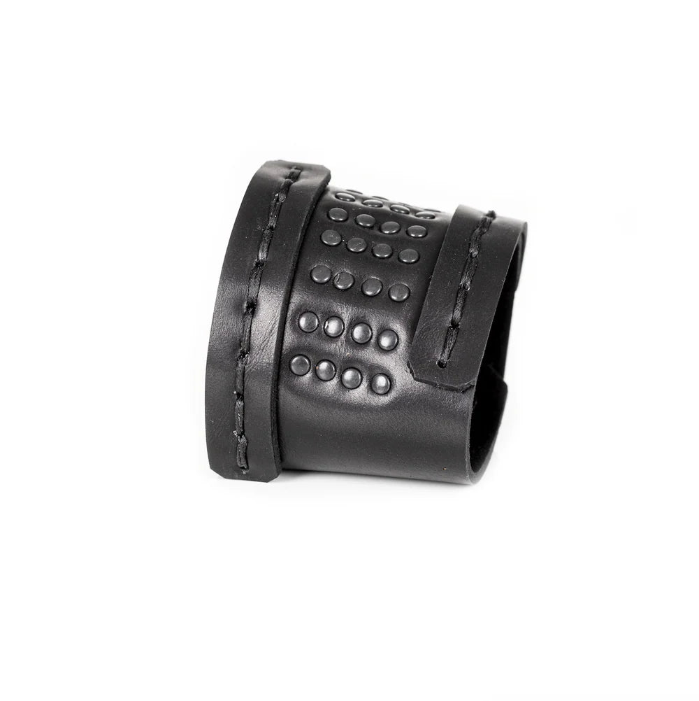 Black genuine leather cuff bracelet with hand-stitched wrap straps and black studded detailing, handcrafted statement accessory on a white background.