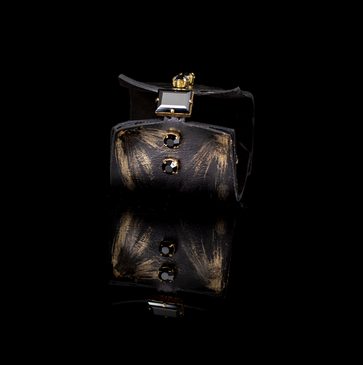Black leather cuff bracelet with gold brushstroke accents and black crystals, handmade statement bracelet by THE DARK