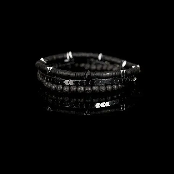 Black beaded bracelet on a black background