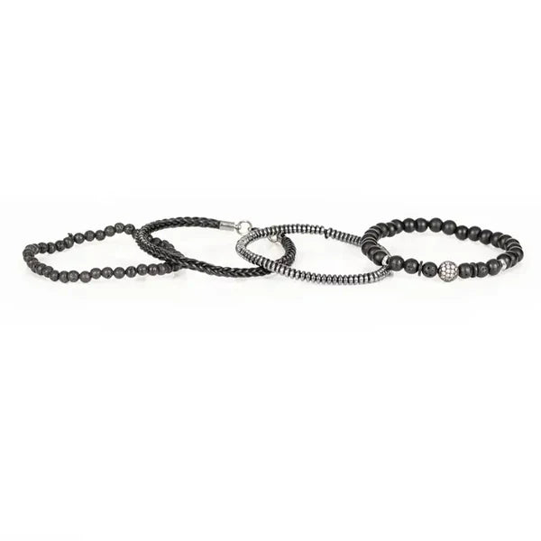 Black layered men’s bracelet with lava stone beads, braided leather detail, silver-tone accents, and crystal pavé centerpiece on a white background.