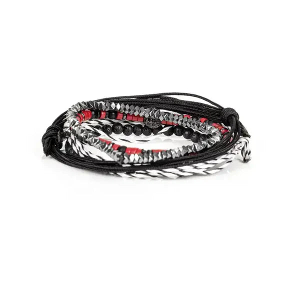 Layered men’s bracelet set featuring black braided cord, red heishi beads, faceted hematite beads, black lava stone beads, a black-and-white woven bracelet, and a pavé crystal centerpiece, displayed on a white background.