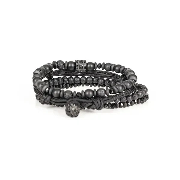 Men's layered black beaded bracelet set featuring matte black beads, lava stone beads, hematite spacers, braided cord strands, and a black pavé cubic zirconia accent bead for a modern luxury look.