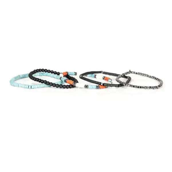 Layered men’s bracelet set featuring turquoise heishi beads, black matte beads, orange accent beads, and silver-tone hematite beads on elastic strands, displayed on a white background