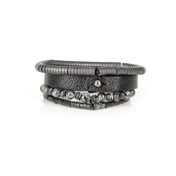 Layered men’s bracelet set featuring a black leather cuff, matte black hematite disc beads, gray natural stone beads, and metallic accent spacers, displayed on a white background.