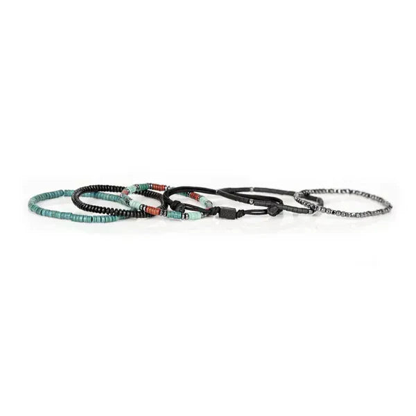 Layered men’s bracelet set featuring black hematite beads, turquoise and coral heishi bead accents, black braided cord details, and geometric metal elements, displayed on a white background.