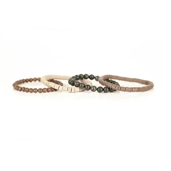 Layered men’s bracelet set featuring taupe and ivory heishi beads, natural green stone beads, and matte bronze beads on elastic strands, displayed on a white background.