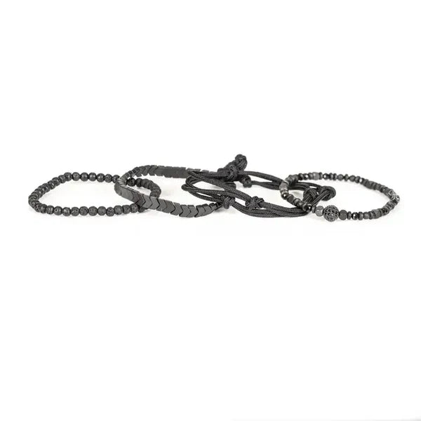 Black layered men’s bracelet with lava stone beads, hematite accents, braided cord, and adjustable closure on a white background.