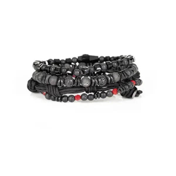 Layered men’s bracelet set featuring black lava stone beads, faceted black crystal beads, matte gray stone beads, braided black cord wraps, red accent beads, and a black arrow-shaped centerpiece, displayed on a white background.