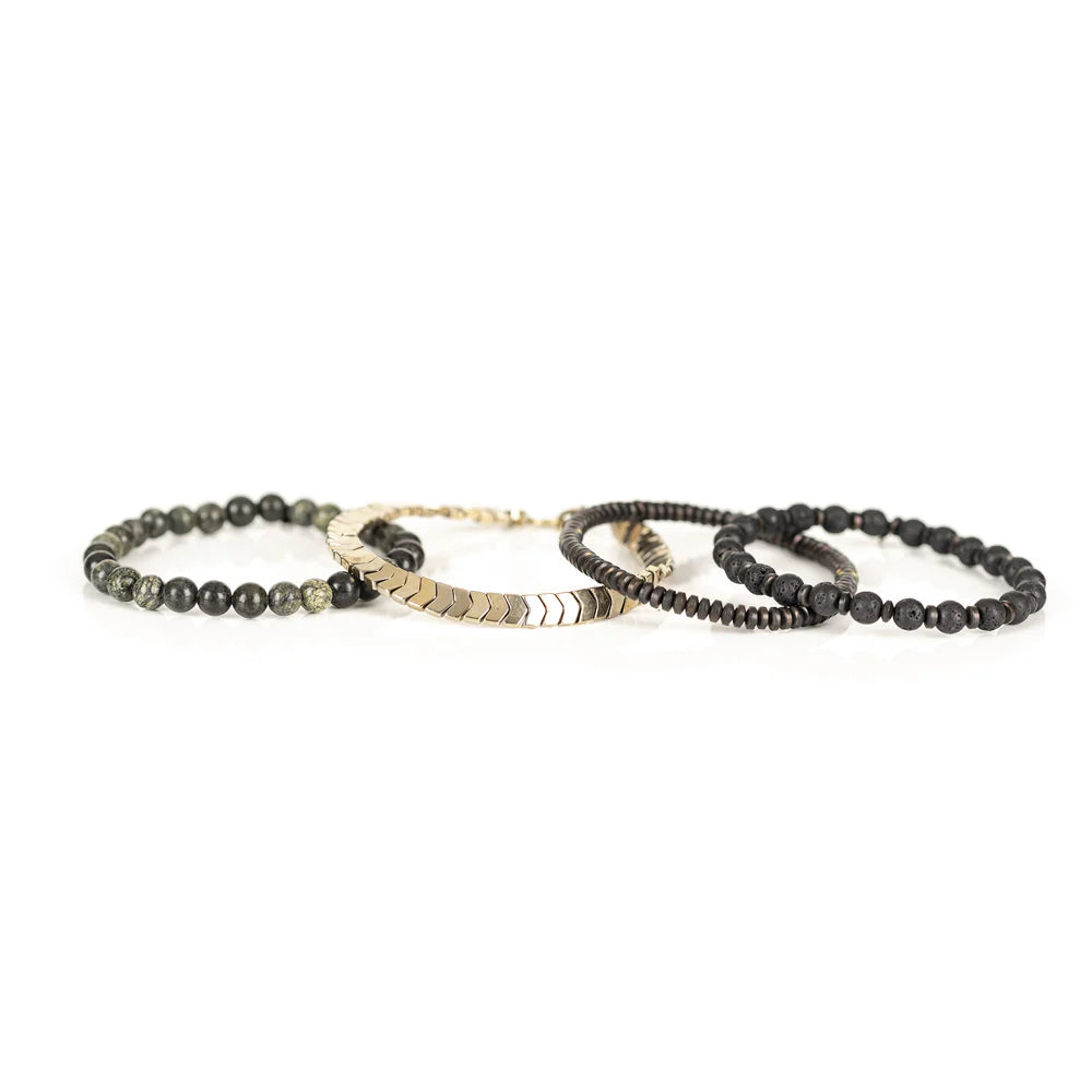 Men's handcrafted layered bracelet set featuring black lava stone beads, natural green serpentine gemstone beads, bronze hematite spacer beads, and gold hematite arrow-shaped beads. Premium stacked men's bracelet photographed on a clean white background.