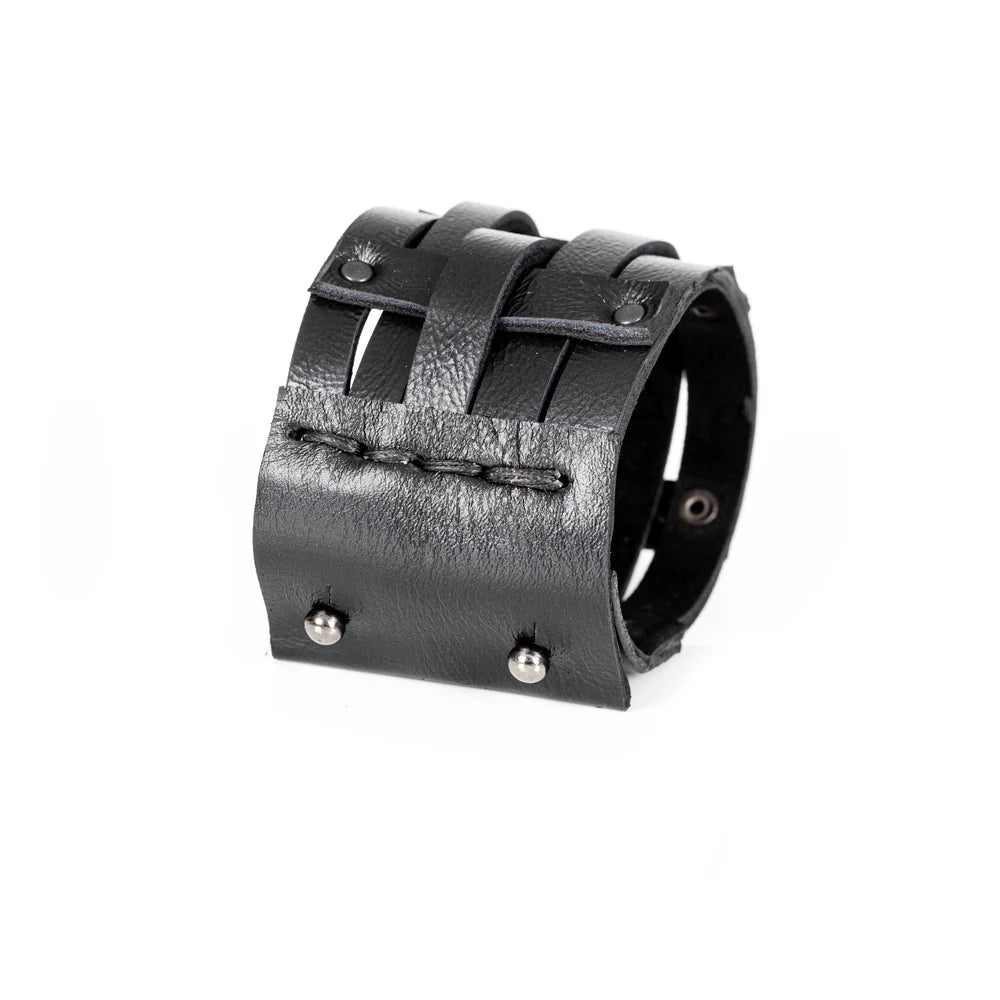 Black genuine leather cuff bracelet featuring an open cage design with layered leather straps and black rivet accents, handcrafted statement accessory on a white background.