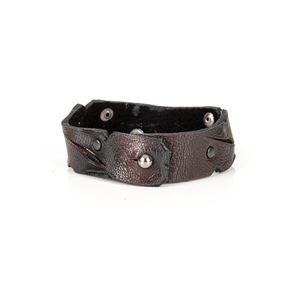 Black genuine leather cuff bracelet with sculpted wave-cut edges, black rivet detailing, and a handcrafted artisan finish, displayed on a white background.