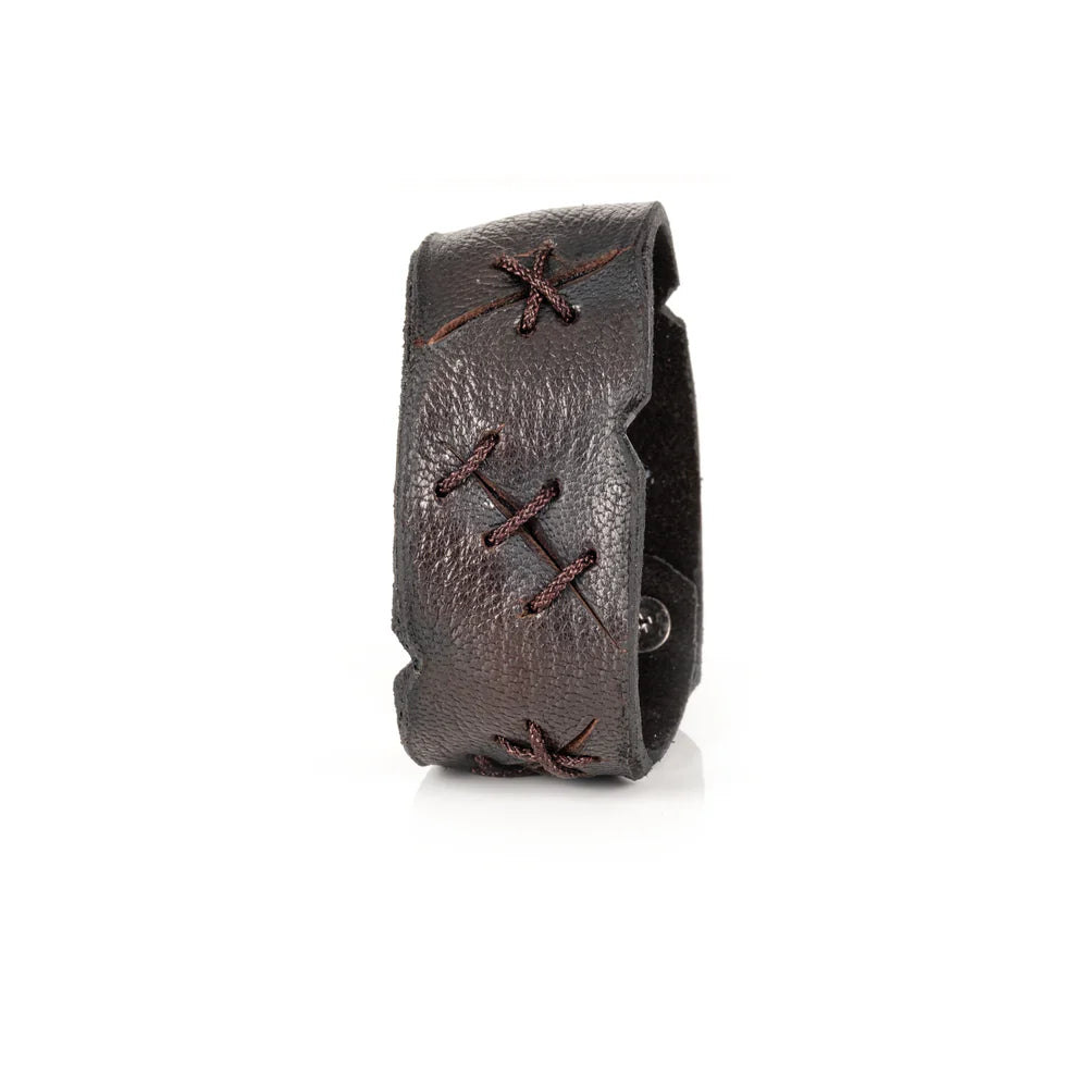 Black genuine leather cuff bracelet with handcrafted lace-up stitching details, rugged artisan finish, and a wide statement silhouette, displayed on a white background.