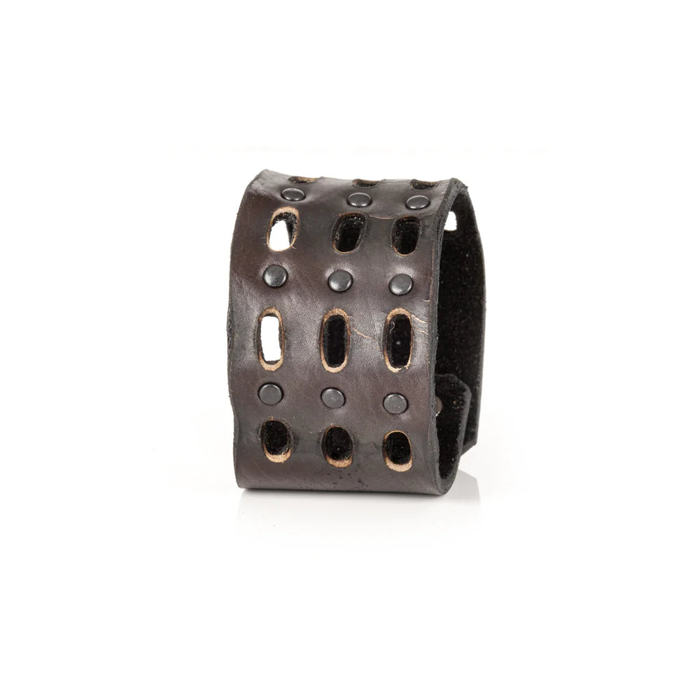 Black genuine leather cuff bracelet with perforated cutout detailing, black rivet accents, and a wide handcrafted statement design, displayed on a white background.