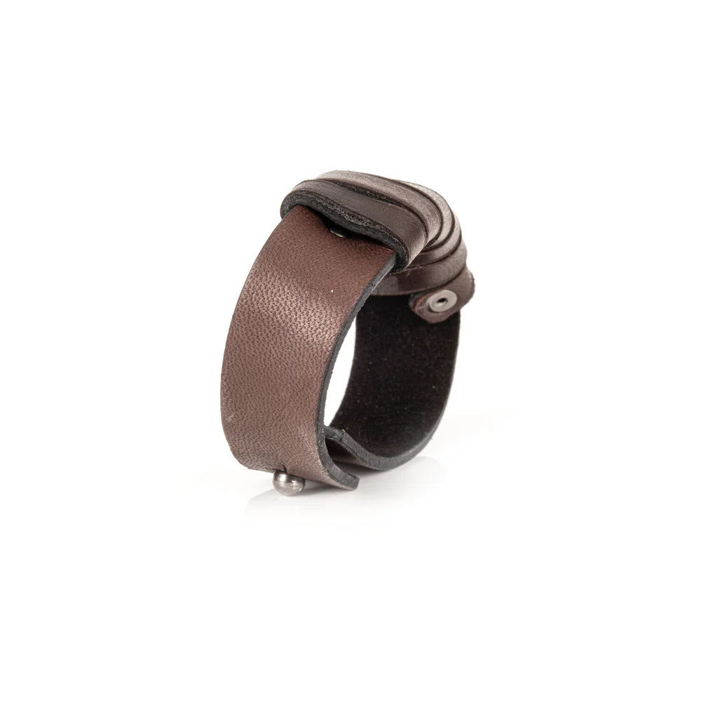 Men's handcrafted genuine leather cuff bracelet in dark brown featuring layered horizontal leather bands with a rugged stacked design and premium artisan craftsmanship. Luxury men's leather wristband photographed on a clean white background.