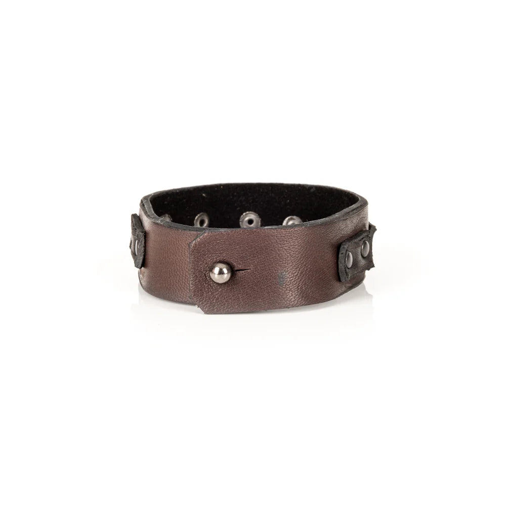 Men's handcrafted genuine leather cuff bracelet in dark brown featuring a wide minimalist design with black leather accent panels, matte black rivet hardware, and premium artisan craftsmanship. Luxury men's leather wristband photographed on a clean white background.