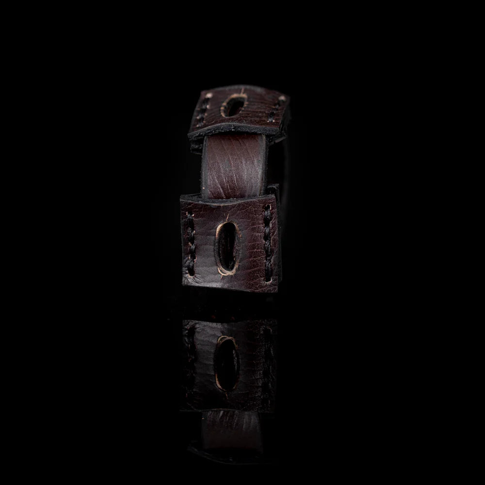 Black genuine leather cuff bracelet featuring layered square leather panels with oval cutout details and hand-stitched accents, handcrafted artisan statement accessory on a white background.