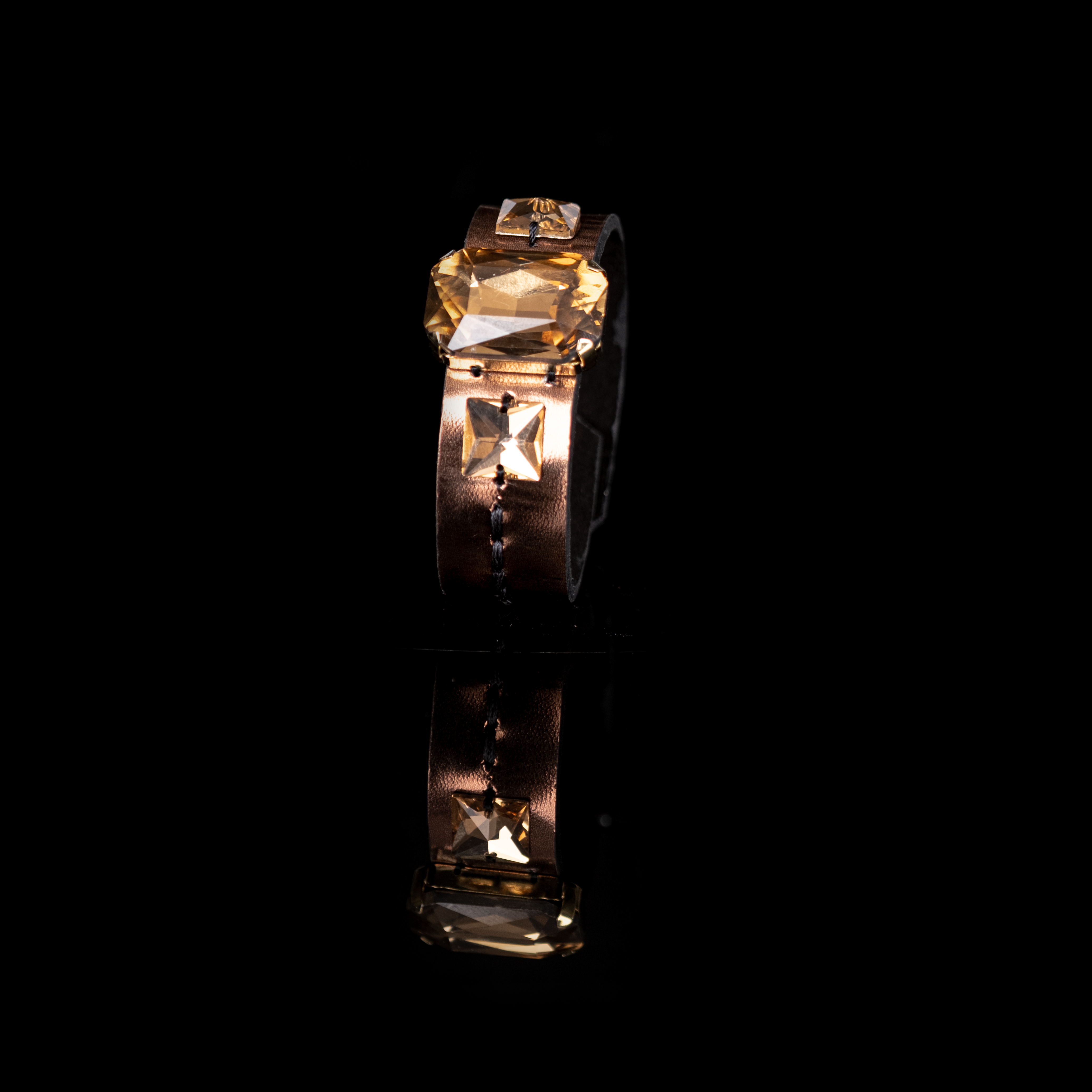 Gold leather cuff bracelet with large amber crystal centerpiece and square crystal accent, handmade statement bracelet by THE DARK