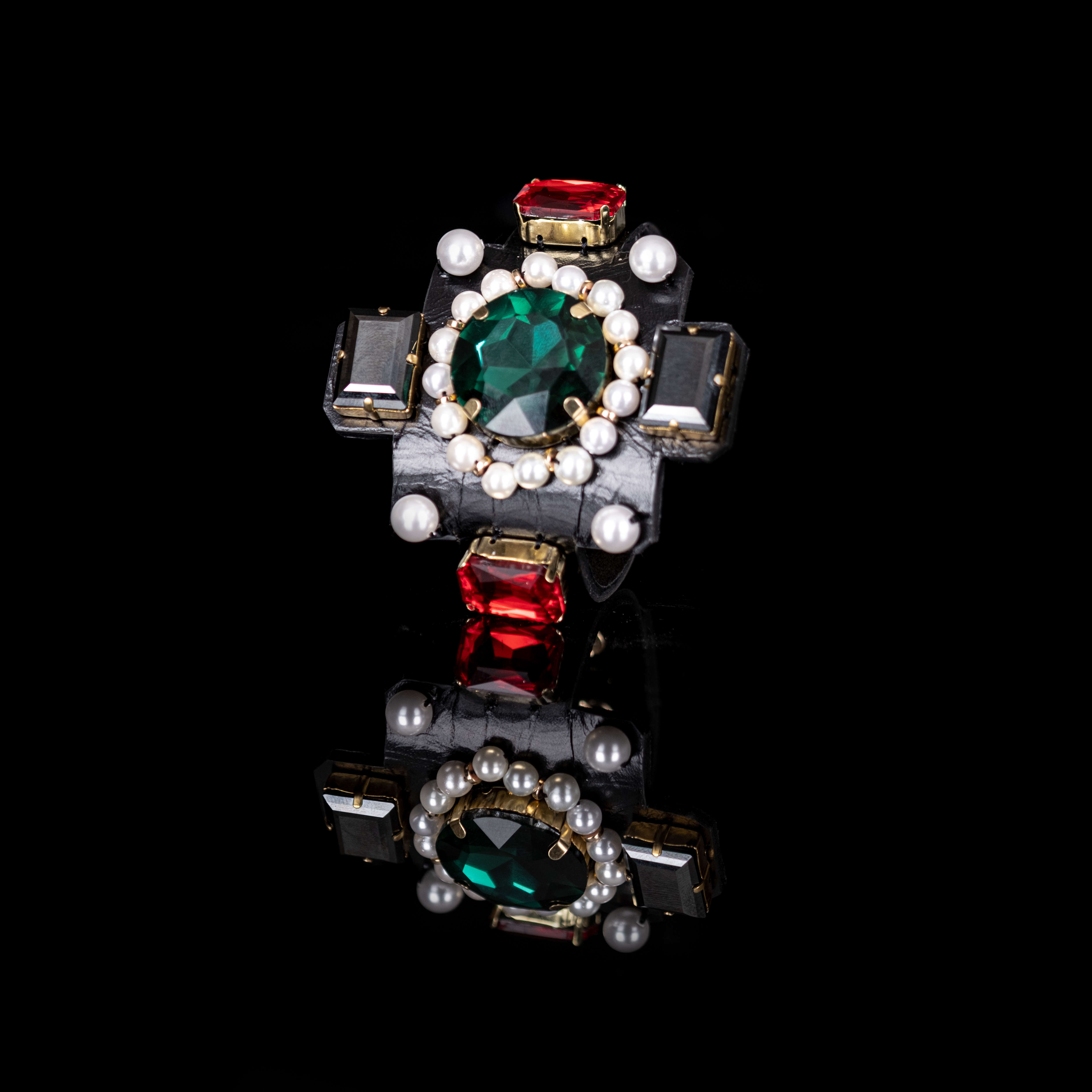 Black leather cuff bracelet with emerald green crystal center, pearl halo and ruby red stones, handmade statement bracelet by THE DARK