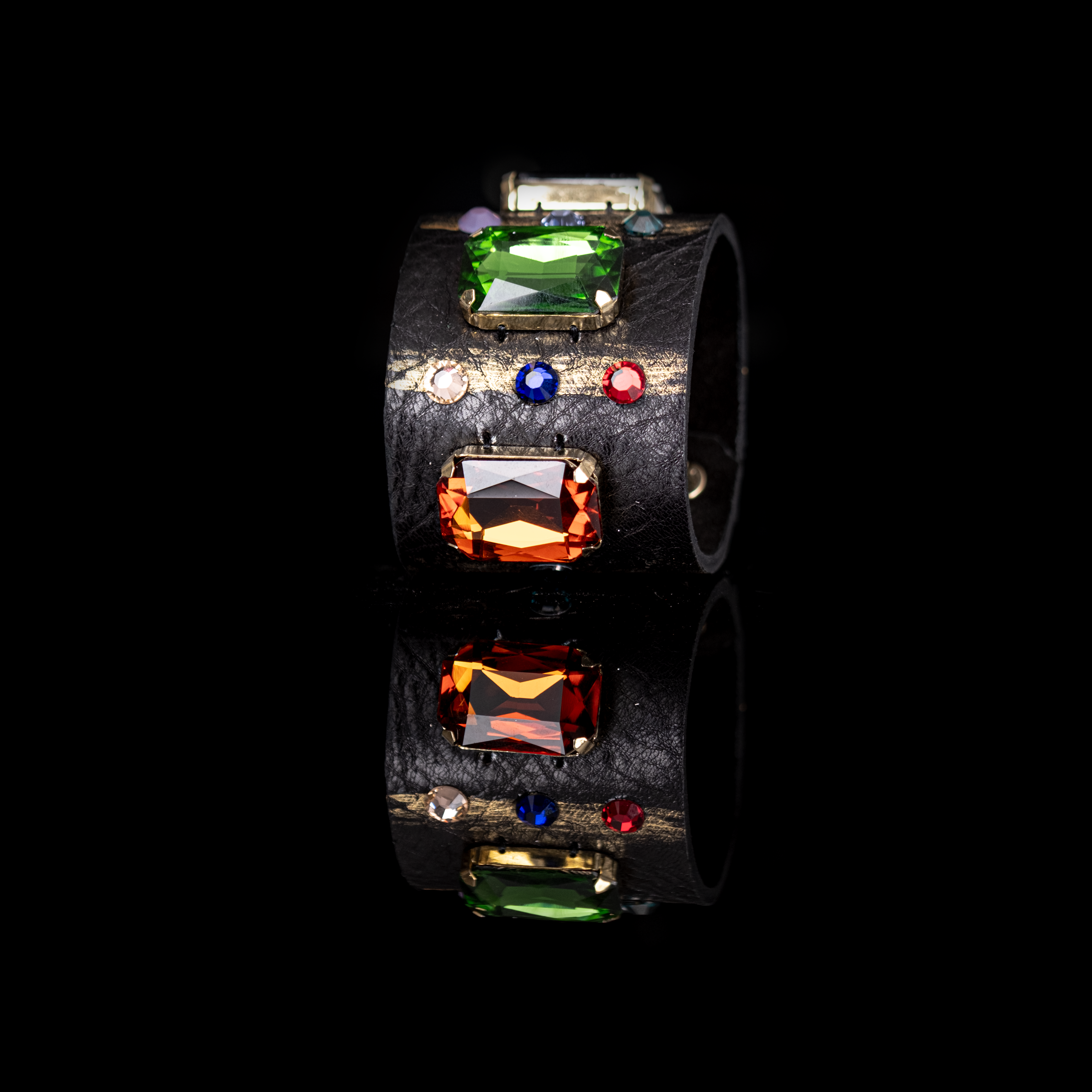 Black leather cuff bracelet with emerald green and amber crystals and multicolor stone accents, handmade statement bracelet by THE DARK