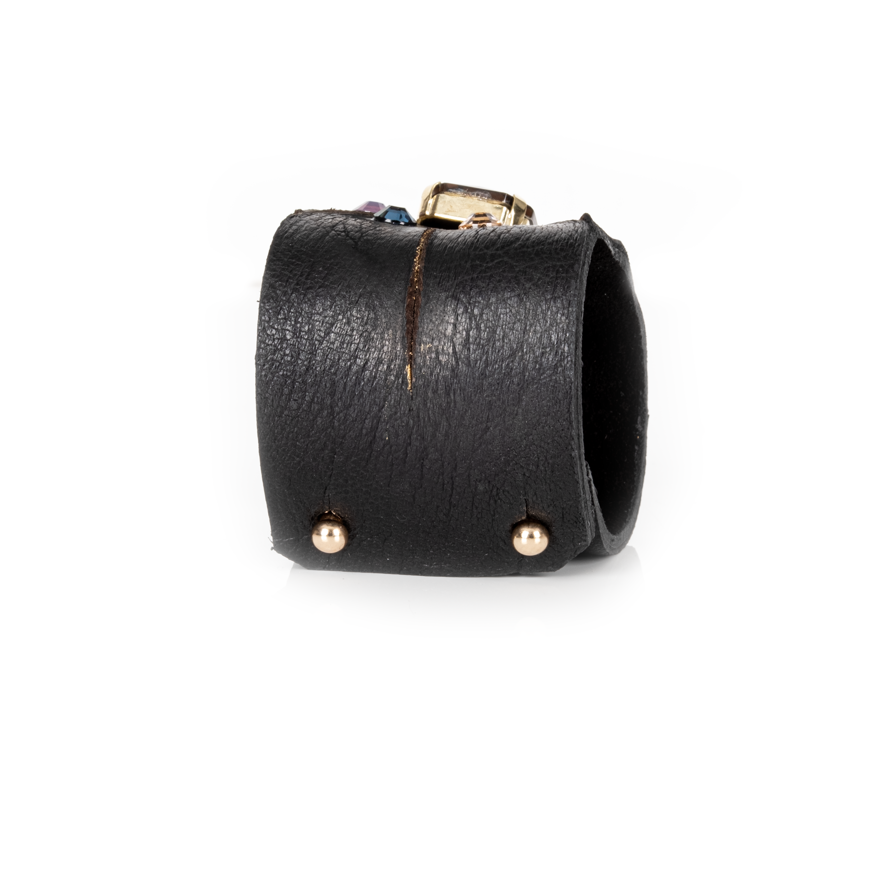 Black leather cuff bracelet with gold accents on a white background