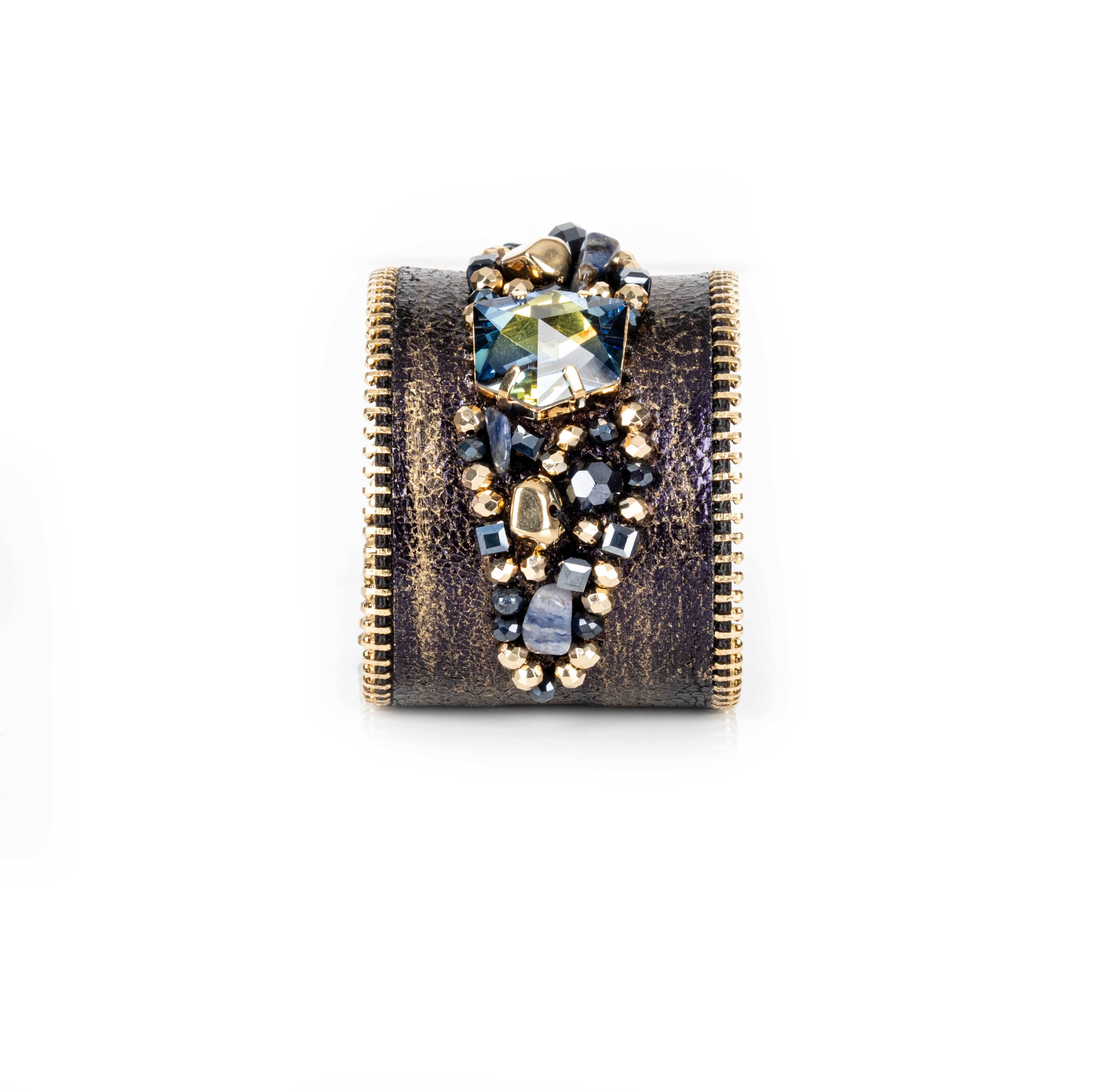 Dark leather cuff with gold brushed finish, zipper edges and blue-toned crystal cluster centerpiece