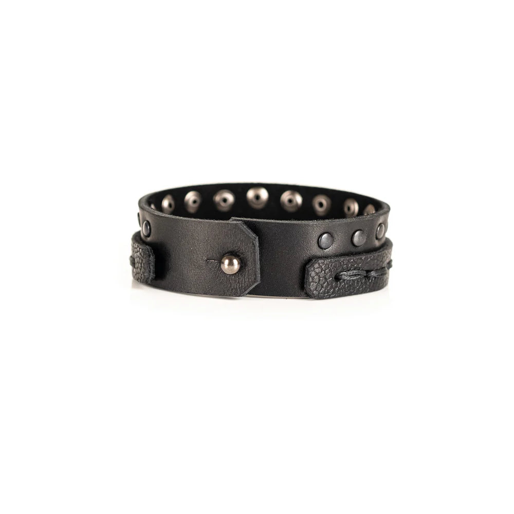 Black genuine leather bracelet featuring a hand-stitched leather band layered with a black studded strap, handcrafted statement accessory on a white background.