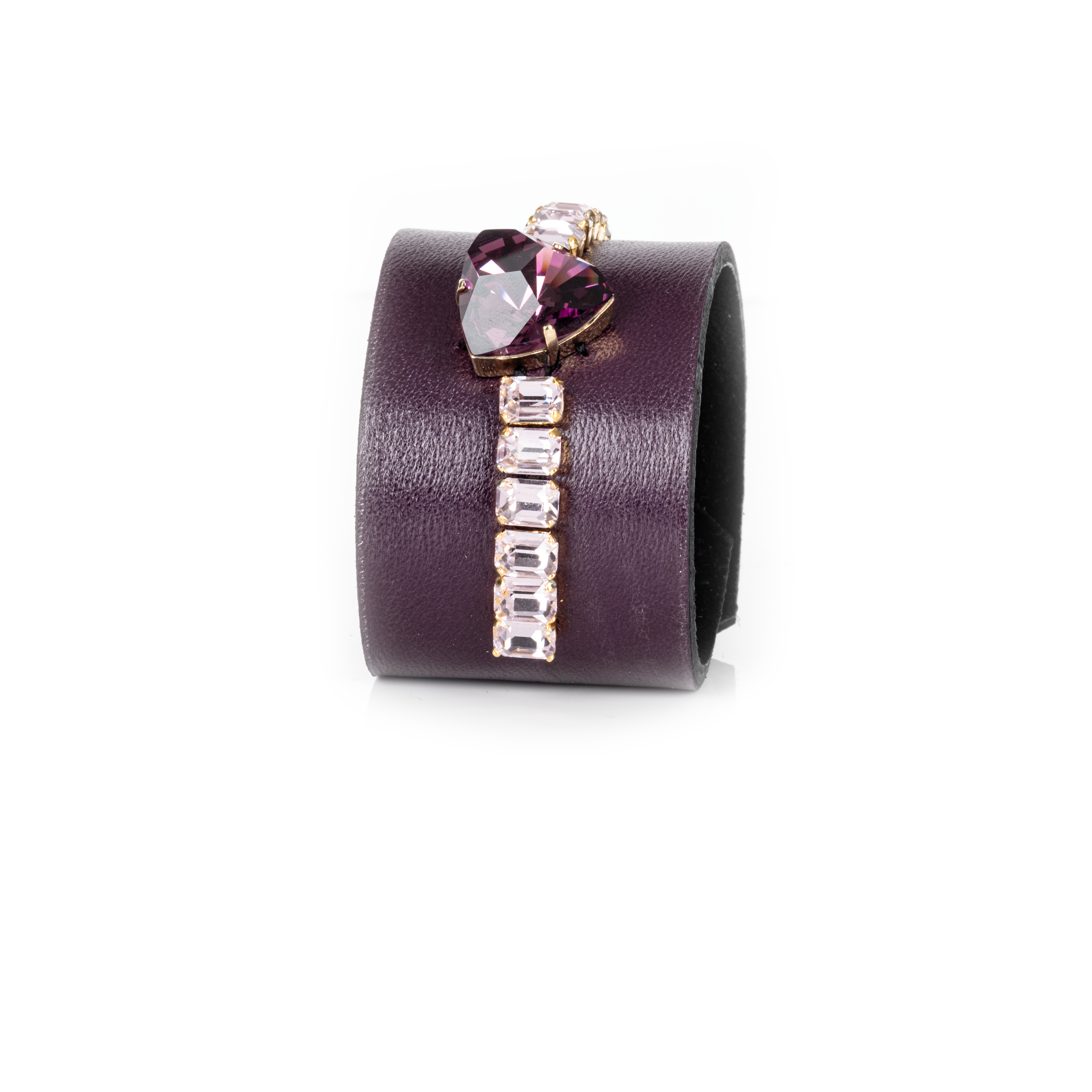 Purple cuff bracelet with a heart-shaped gemstone and clear stones on a white background