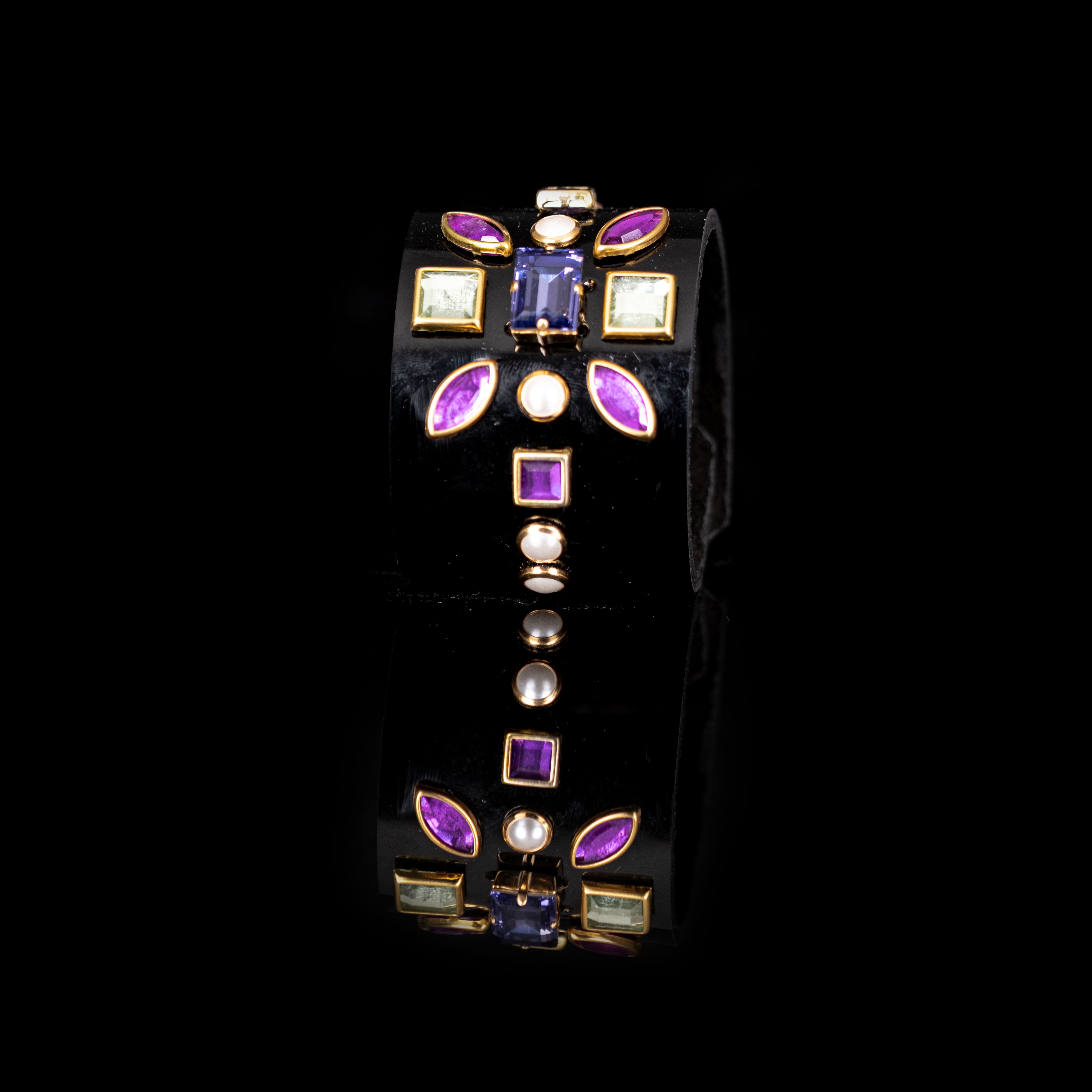 Black leather cuff bracelet with geometric multicolor crystals and gold settings, wide statement bracelet with purple and green gemstone accents for women