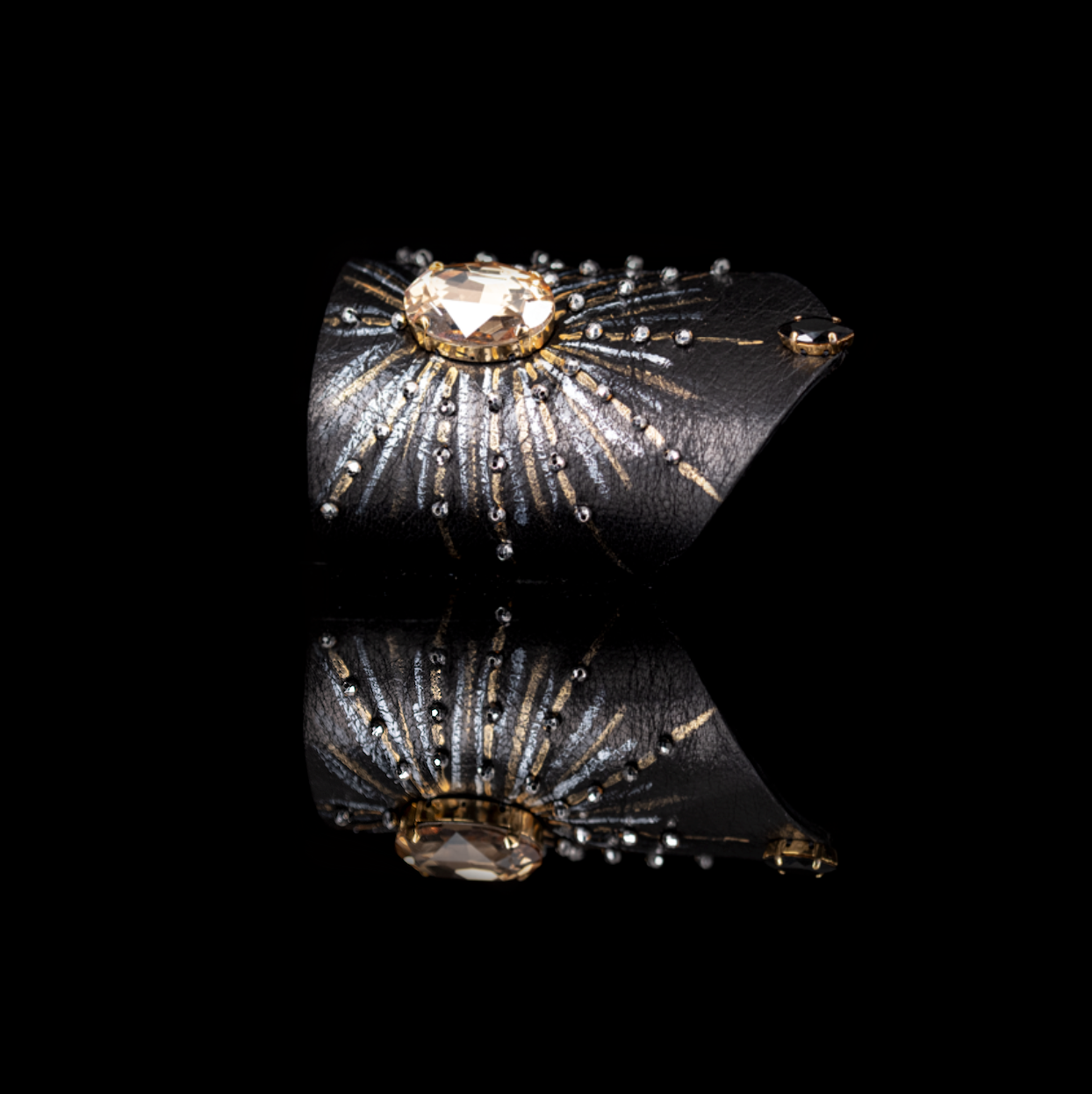 Black leather cuff bracelet with large champagne crystal center and radiating crystal accents, handmade statement bracelet by THE DARK