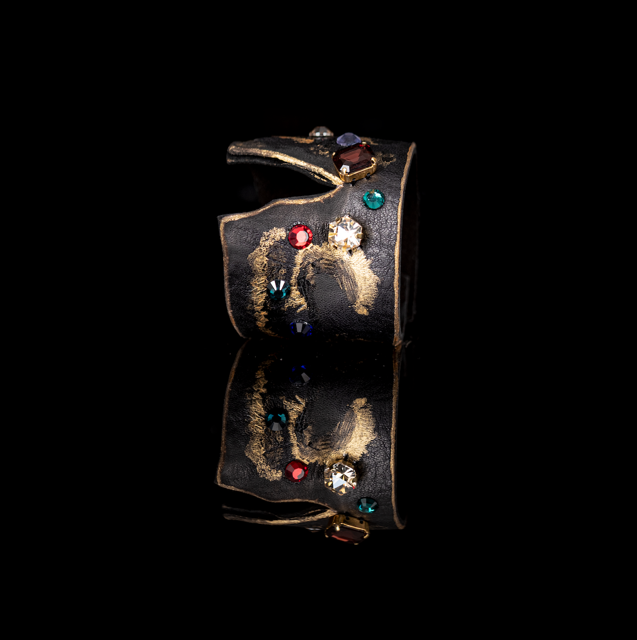 Black leather cuff with gold brushstroke finish and multicolor crystal embellishments, artistic statement bracelet